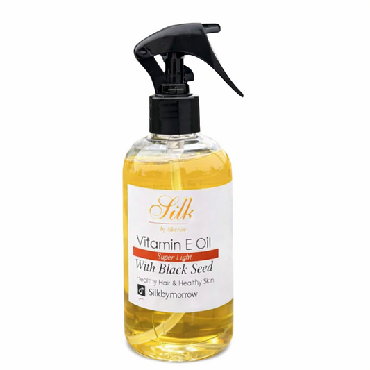 Bottle of Silk Vitamin E Oil with Black Seed on a white background